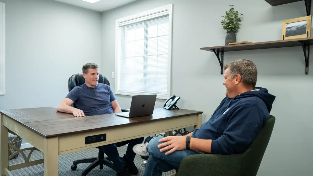 Conversation across the desk in the Edison Electric office
