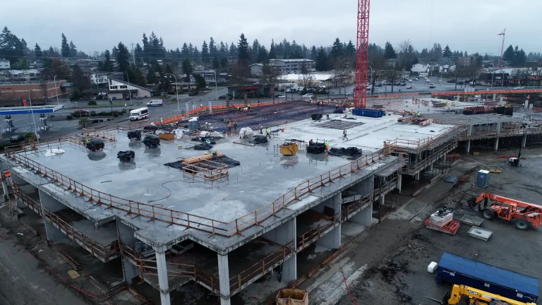 Concrete parking podium deck under construction at Solera with a tower crane overhead