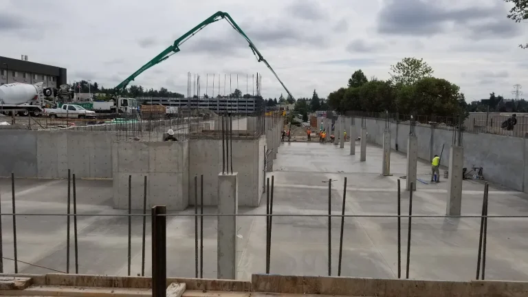 Concrete pump boom over a post-tension deck pour at Waterview Crossing